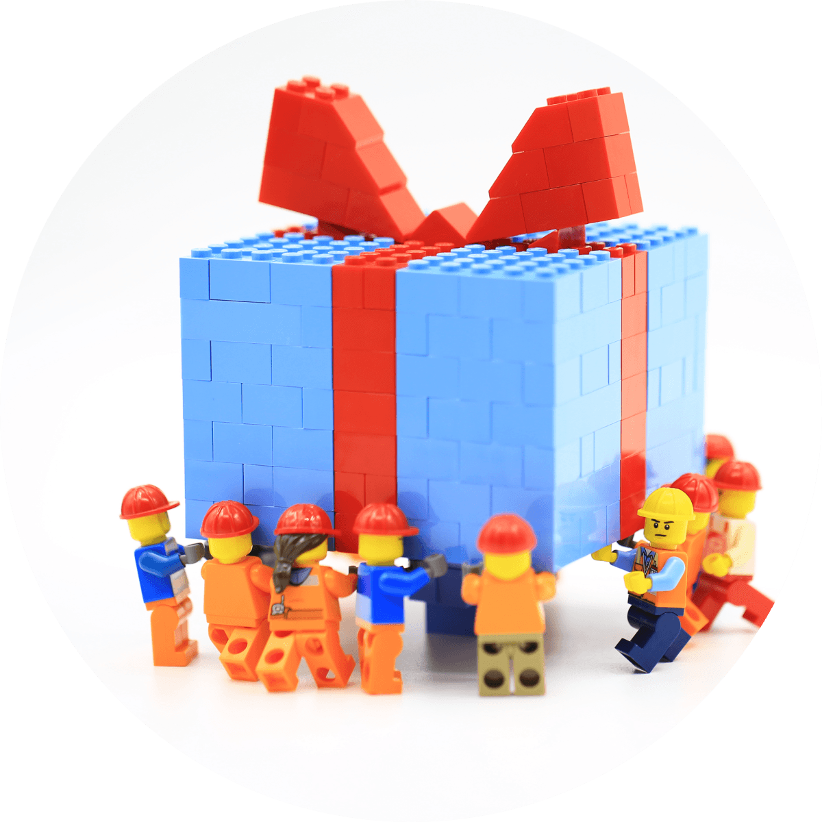 LEGO characters carries blue present box with red ribbon made from LEGO